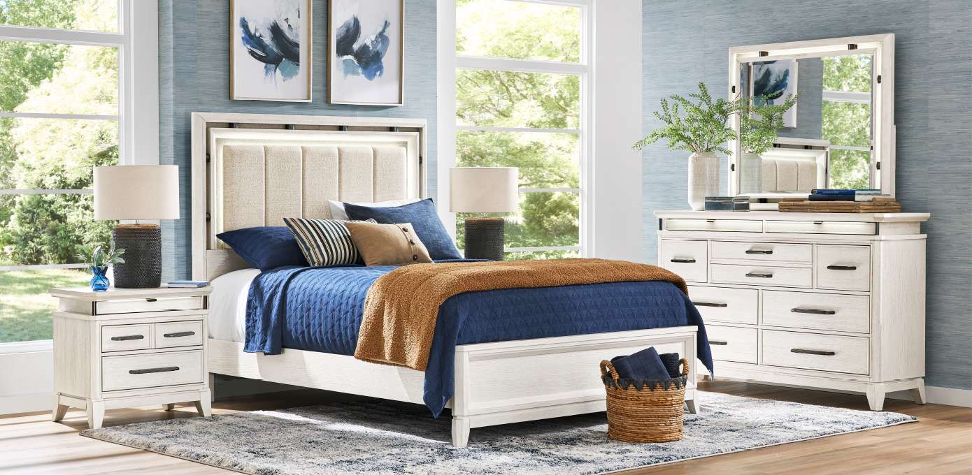 Bedroom furniture set with a bed, nightstands, and dresser.
