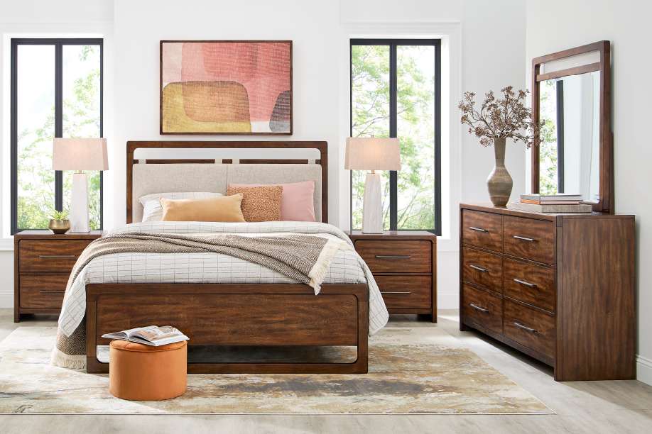 Bedroom furniture set with a bed, nightstands, dresser, and mirror.
