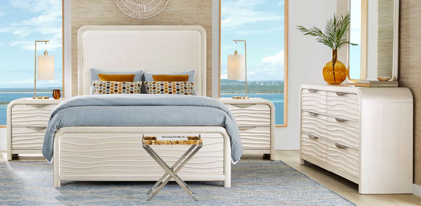 Bedroom furniture set with a bed, nightstands, and dresser.
