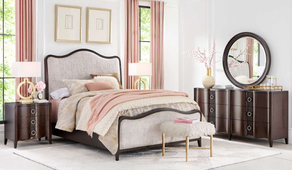 Bedroom furniture set with a bed, nightstand, dresser, and mirror.
