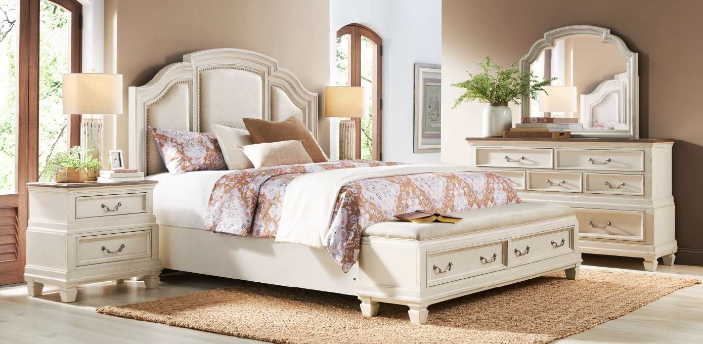 Bedroom furniture set with a bed, nightstands, dresser, and mirror.
