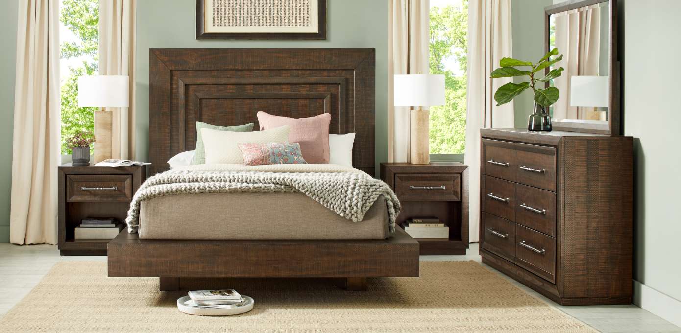 Bedroom furniture set with a bed, nightstands, and dresser.
