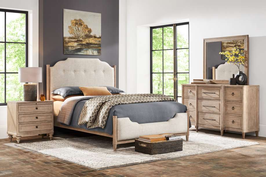 Bedroom furniture set with a bed, nightstand, dresser, and mirror.
