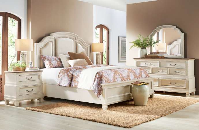 Bedroom furniture set with a bed, nightstands, and dresser.
