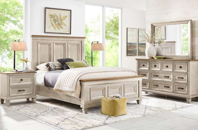 Bedroom furniture set with a bed, nightstand, dresser, and mirror.
