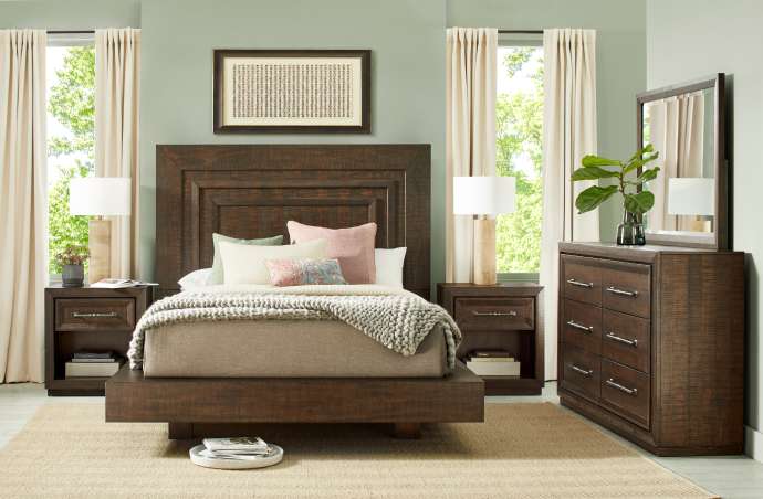 Bedroom furniture set with a bed, nightstands, and dresser.
