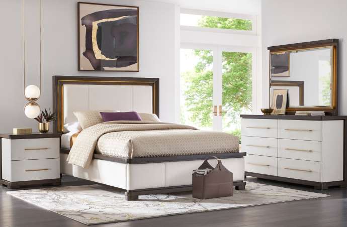 Bedroom furniture set with a bed, nightstand, and dresser.
