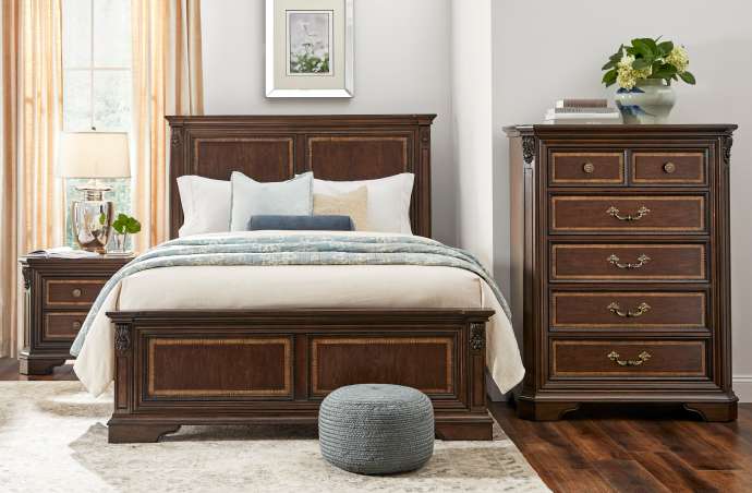 Bedroom furniture set with a bed, nightstand, and chest of drawers.
