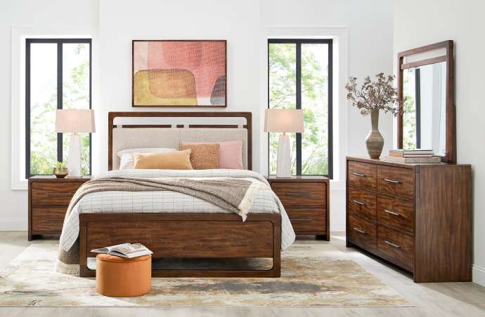 Bedroom furniture set with a bed, nightstands, dresser, and mirror.
