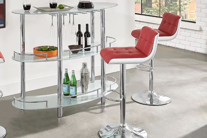 A bar with red and white bar stools.
