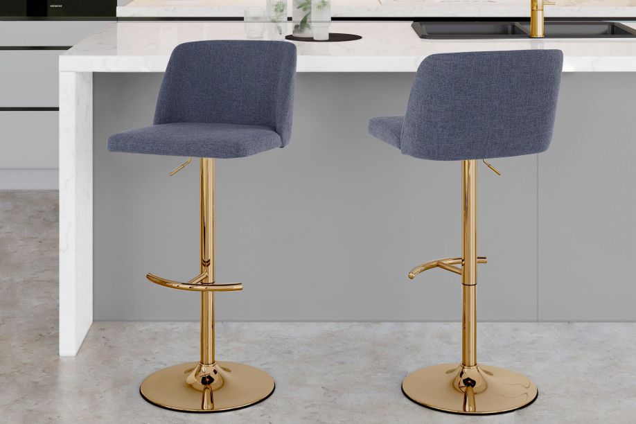 Two blue upholstered bar stools with gold bases.
