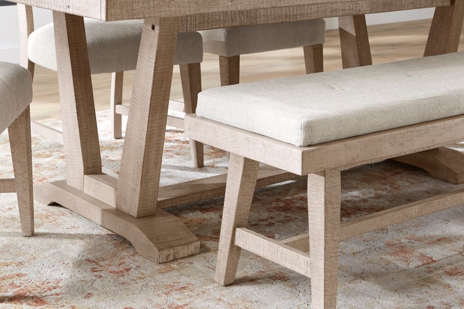 Wooden dining table with a bench and chairs.
