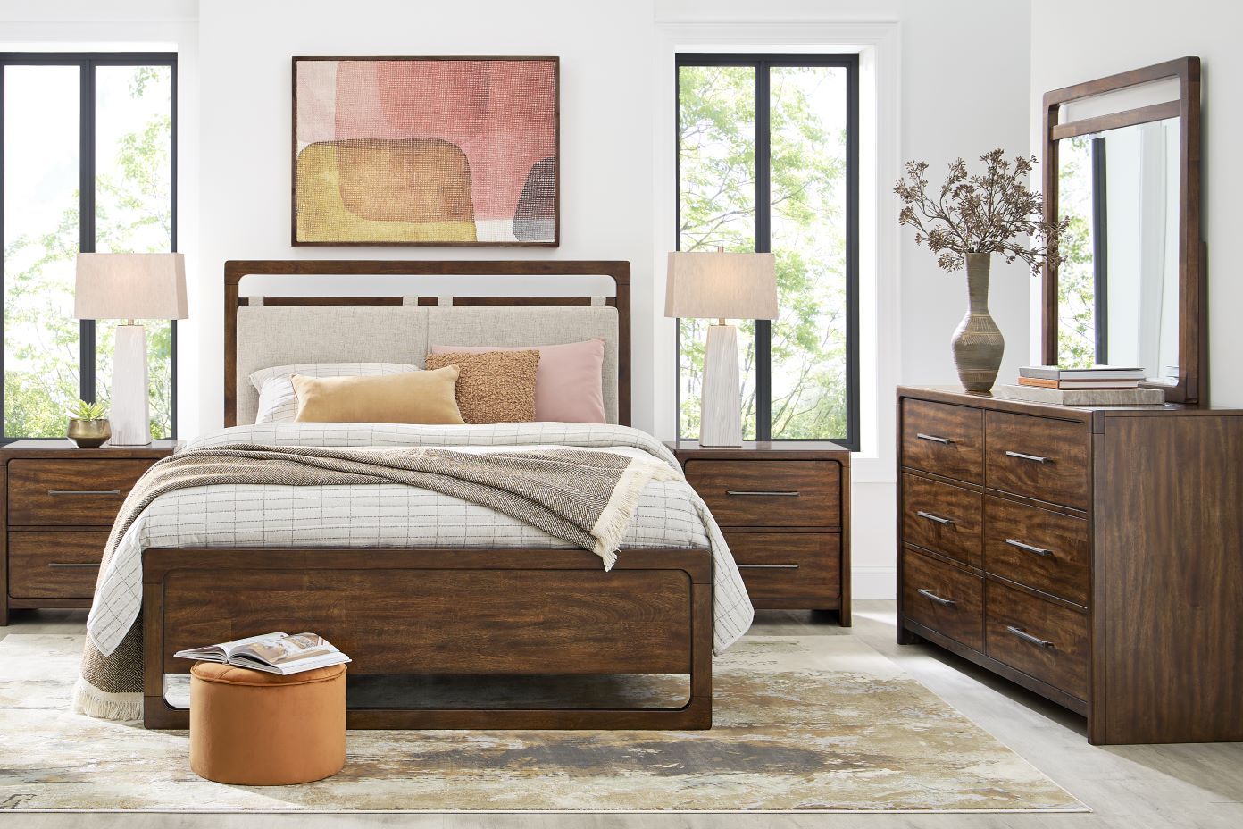 Bedroom furniture set with a bed, nightstands, dresser, and mirror.
