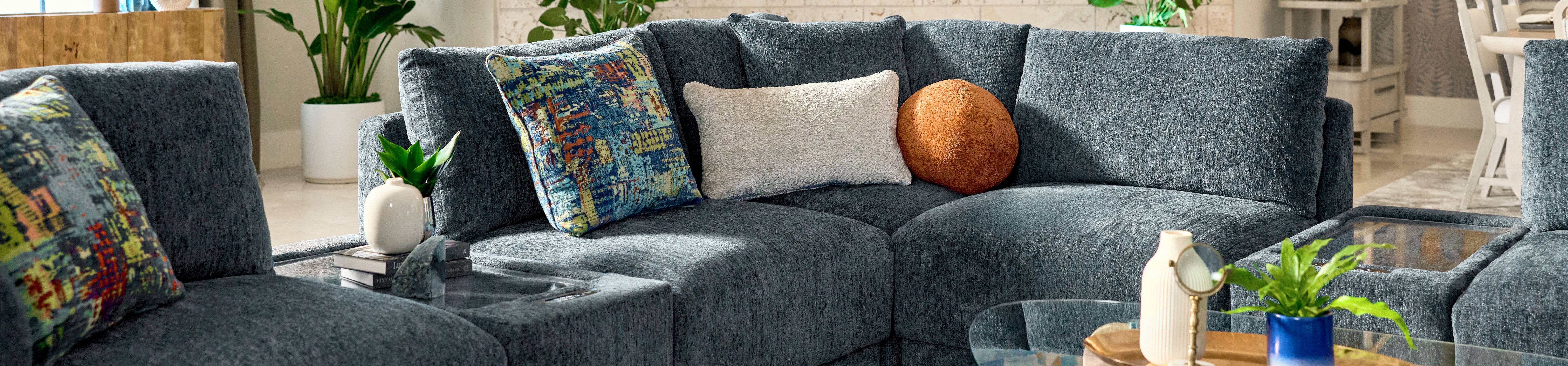 Blue sectional sofa with decorative pillows.