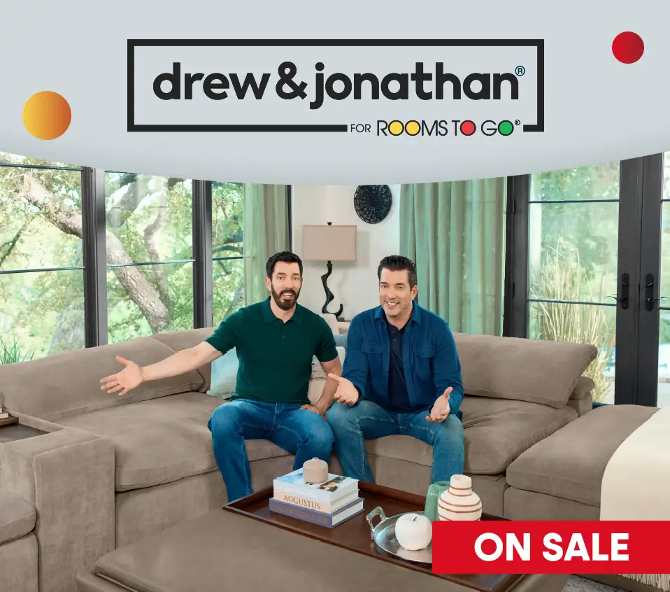 drew & jonathan FOR ROOMS TO GO. Two men sitting on a couch, "ON SALE" text.