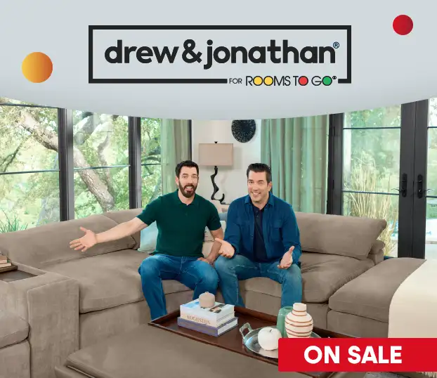 drew & jonathan for rooms to go. On sale. Two men sitting on a couch.