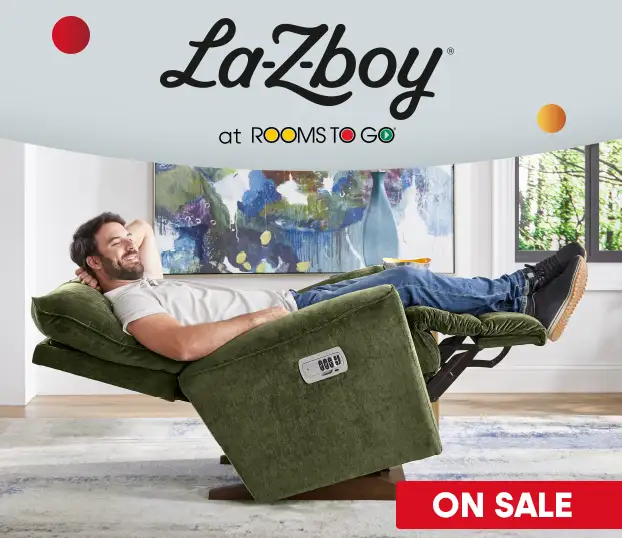 La-Z-Boy at Rooms To Go. Man reclining in a green recliner. On Sale.