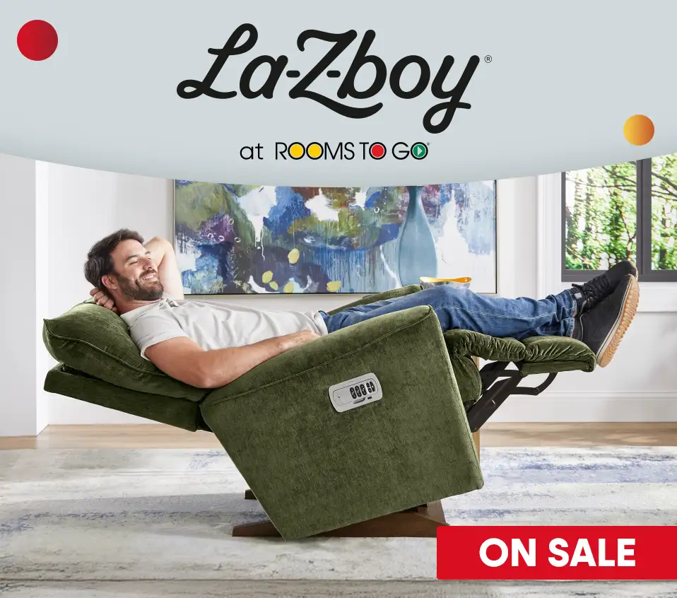 La-Z-boy at Rooms To Go. Man reclining in a green recliner. On sale.