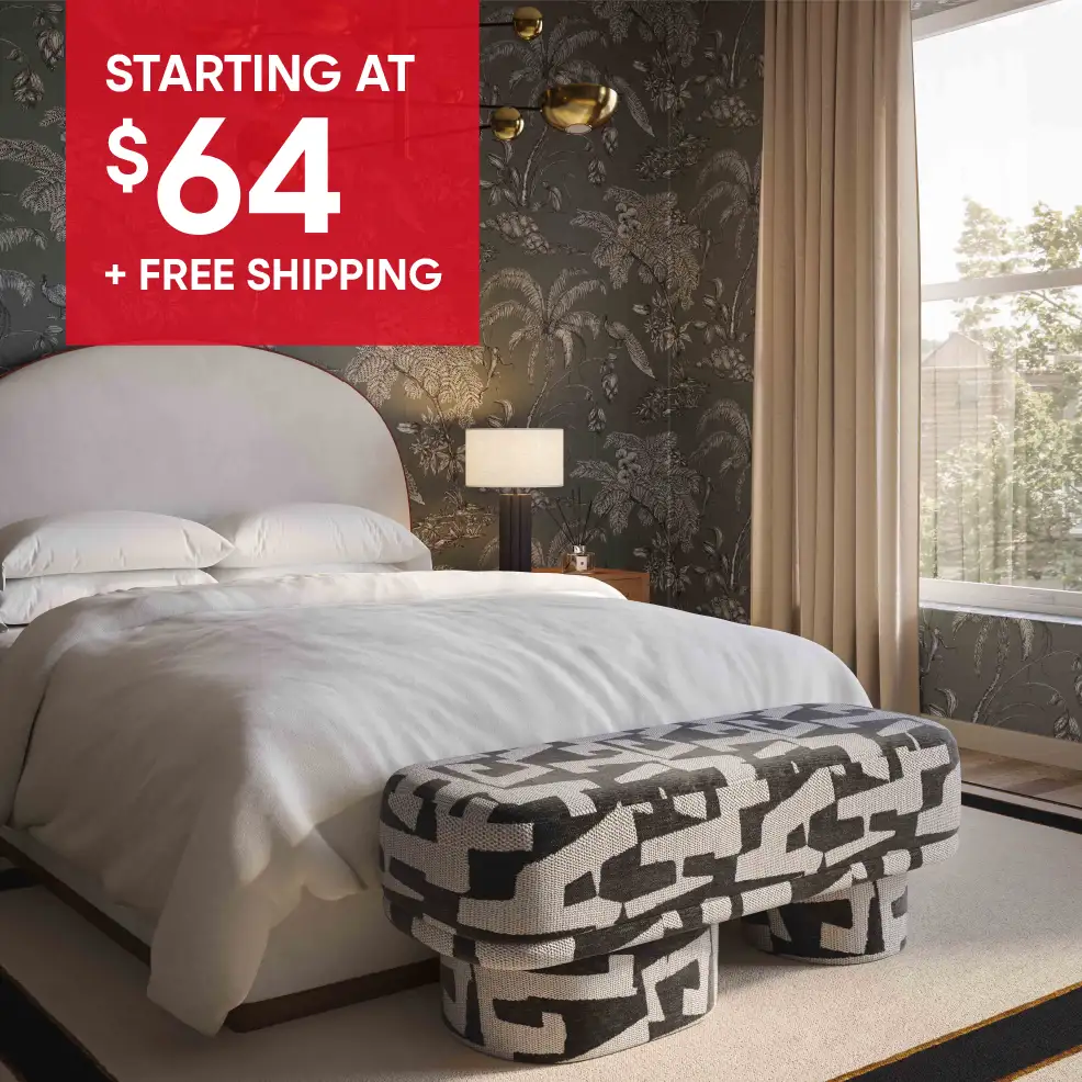 STARTING AT $64 + FREE SHIPPING. Bedroom with a bed, bench, and patterned wallpaper.