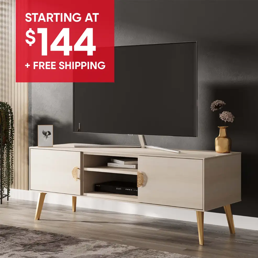 STARTING AT $144 + FREE SHIPPING. A light wood-tone TV stand with gold accents and a TV on top.