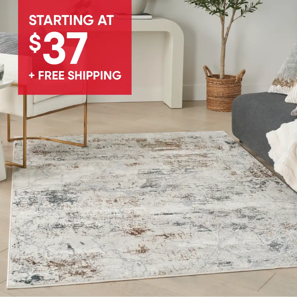 STARTING AT $37 + FREE SHIPPING. A rug with a distressed pattern.