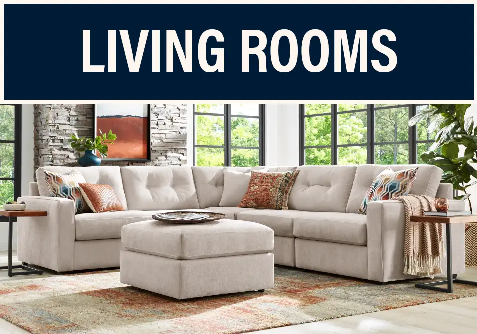 LIVING ROOMS. A sectional sofa with an ottoman in a living room.