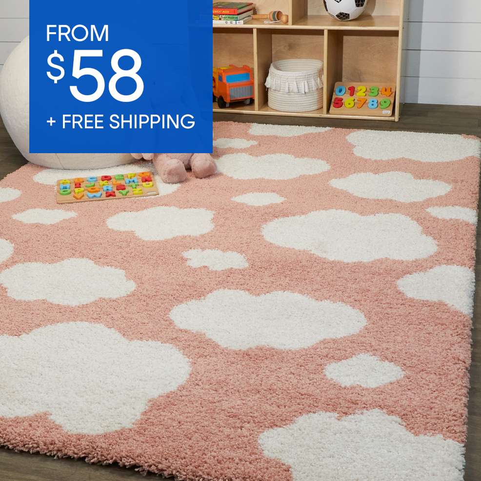 FROM $58 + FREE SHIPPING. A pink and white cloud-patterned rug.
