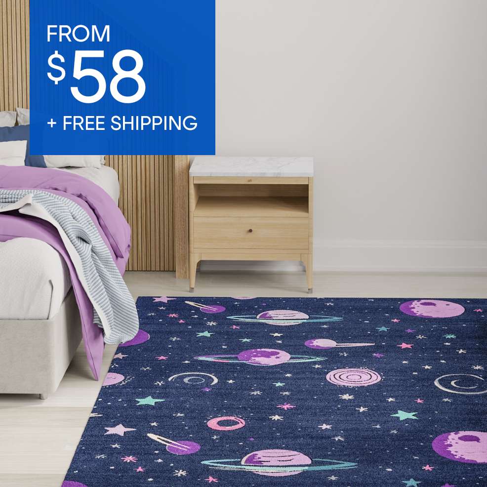 FROM $58 + FREE SHIPPING. A dark blue rug with a space-themed pattern is in a bedroom.
