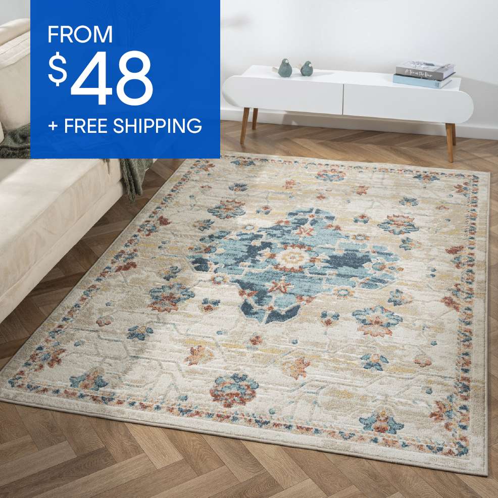 FROM $48 + FREE SHIPPING. A beige and blue patterned rug on a wooden floor.
