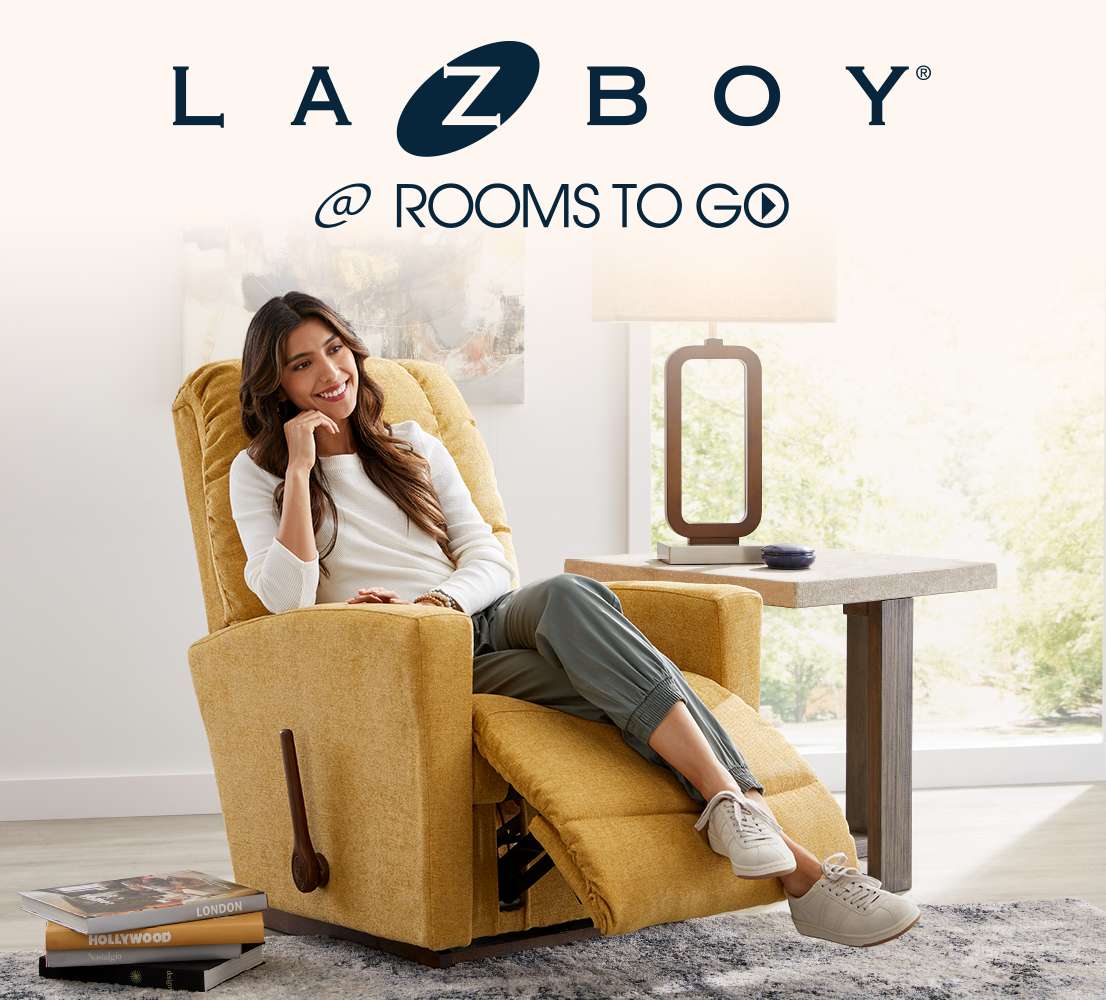 LAZBOY @ ROOMS TO GO. A woman sits in a yellow recliner.
