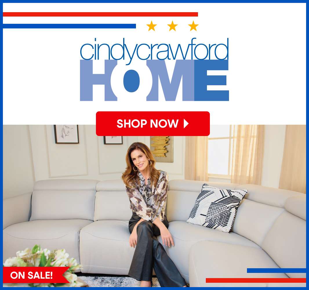 Cindy Crawford Home. Shop Now. On Sale! Woman sitting on a light gray sectional sofa.
