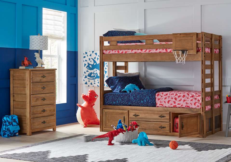 A wooden bunk bed with dinosaur-themed bedding and decor in a child's room.
