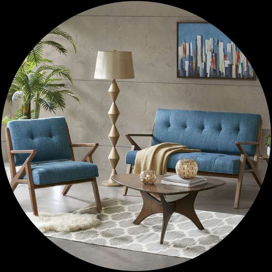 Living room with blue sofa and chair, wooden coffee table, and floor lamp.
