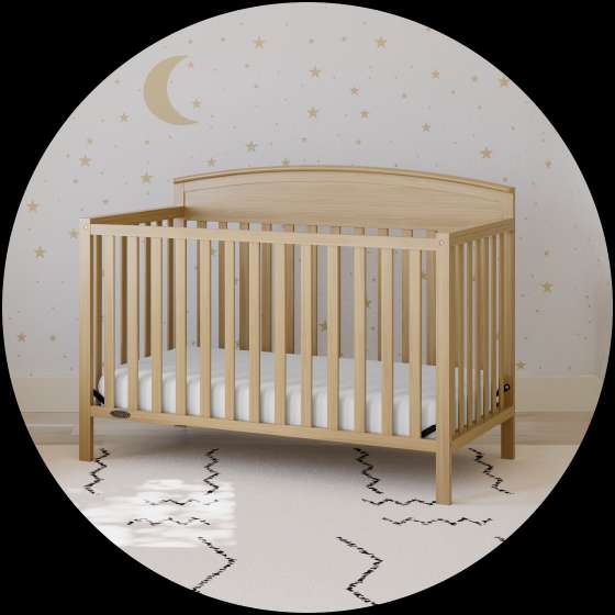 Wooden crib in a nursery with a star and moon wallpaper.
