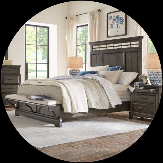 Bedroom furniture set with a bed, nightstands, and a bench.
