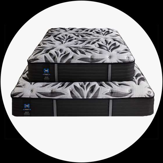 Two Sealy mattresses stacked on top of each other.
