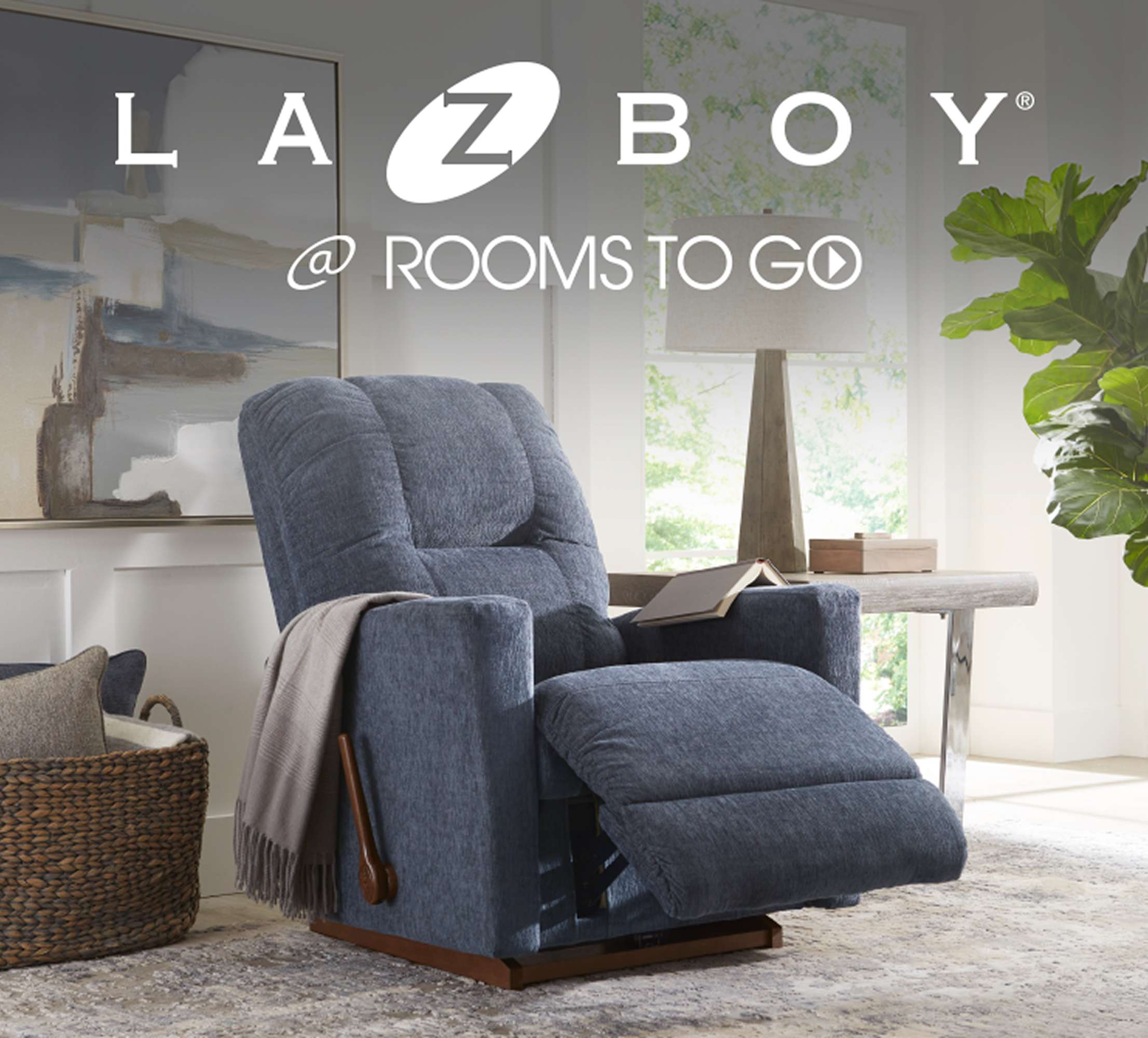 LAZBOY @ ROOMS TO GO. A blue recliner chair in a living room setting.
