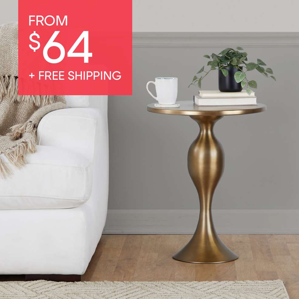FROM $64 + FREE SHIPPING. A gold side table with a plant, books, and a mug.

