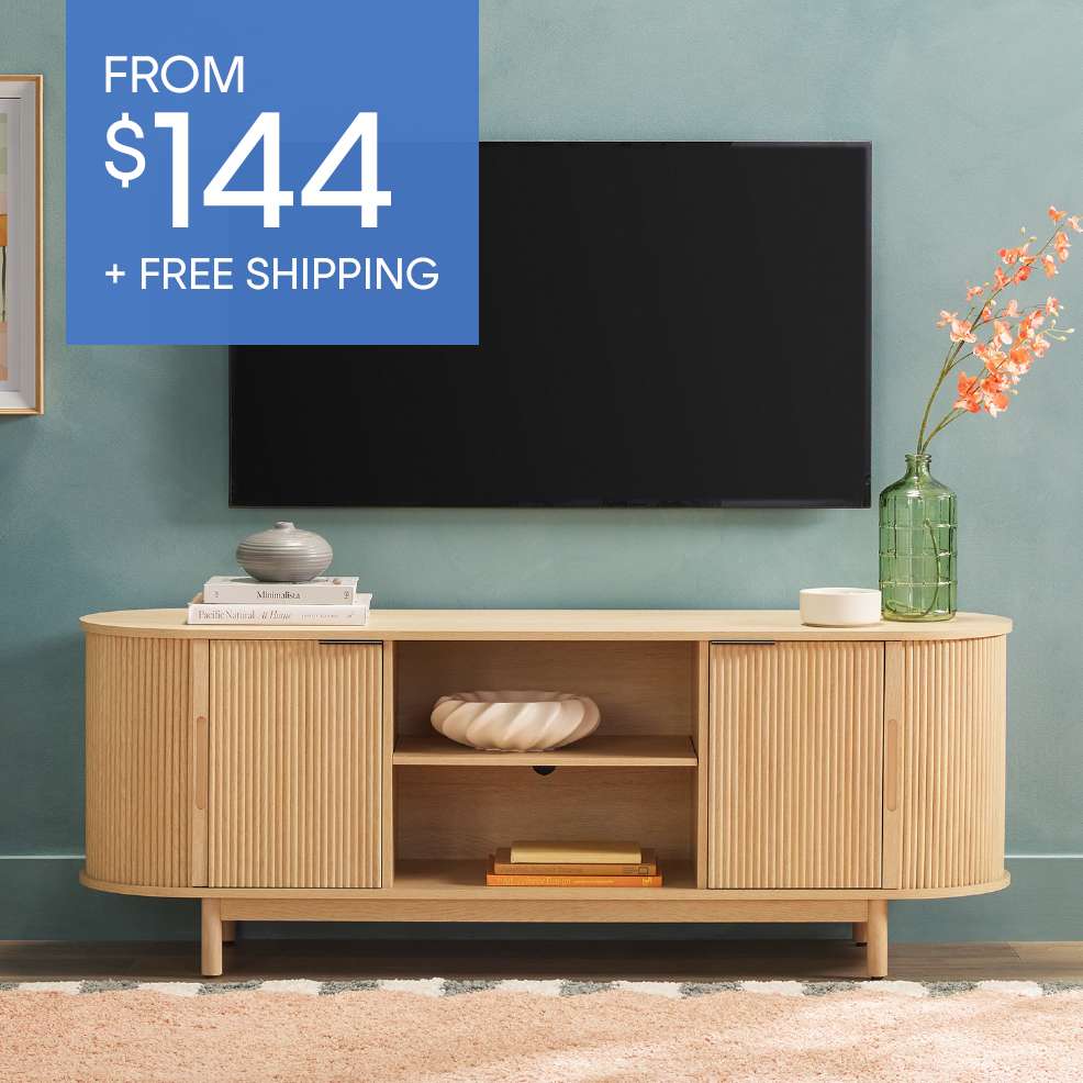 FROM $144 + FREE SHIPPING. A wooden TV stand with a TV above it.
