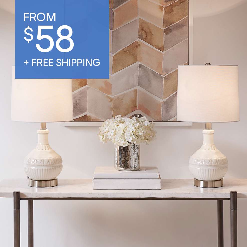 FROM $58 + FREE SHIPPING. Two white lamps on a marble table.
