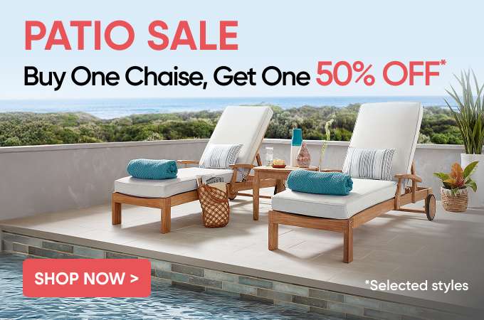 PATIO SALE: Buy One Chaise, Get One 50% OFF. Two wooden chaise lounges on a patio with a pool.
