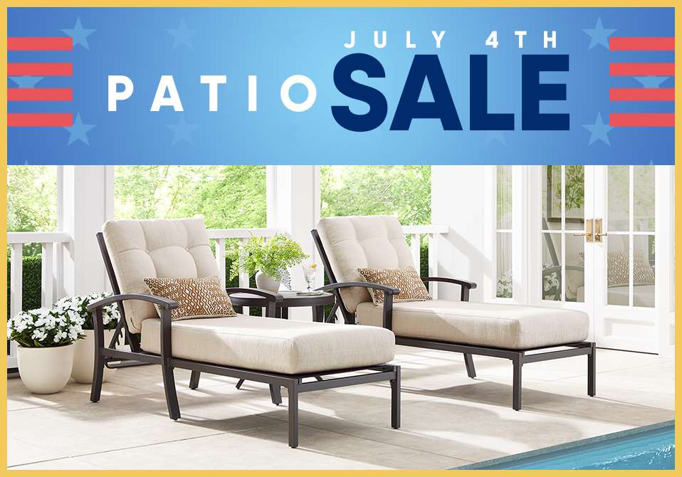 PATIO SALE JULY 4TH. Two beige chaise lounges on a patio.
