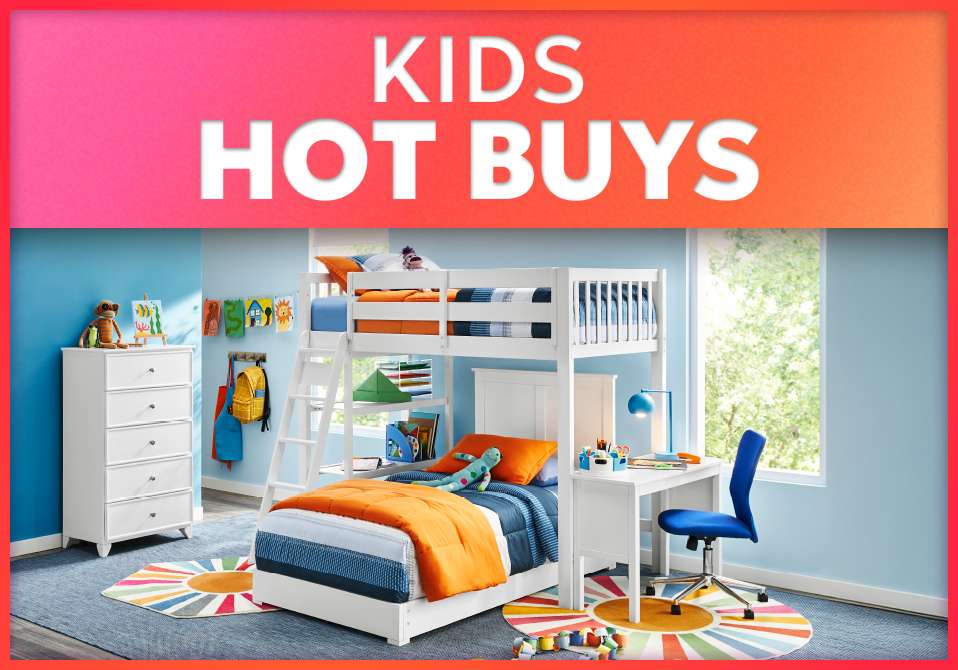 KIDS HOT BUYS. A white bunk bed with a desk and a blue chair in a child's bedroom.
