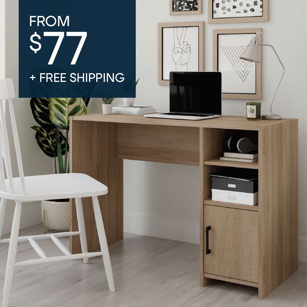 FROM $77 + FREE SHIPPING. A wooden desk with a laptop, lamp, and storage.

