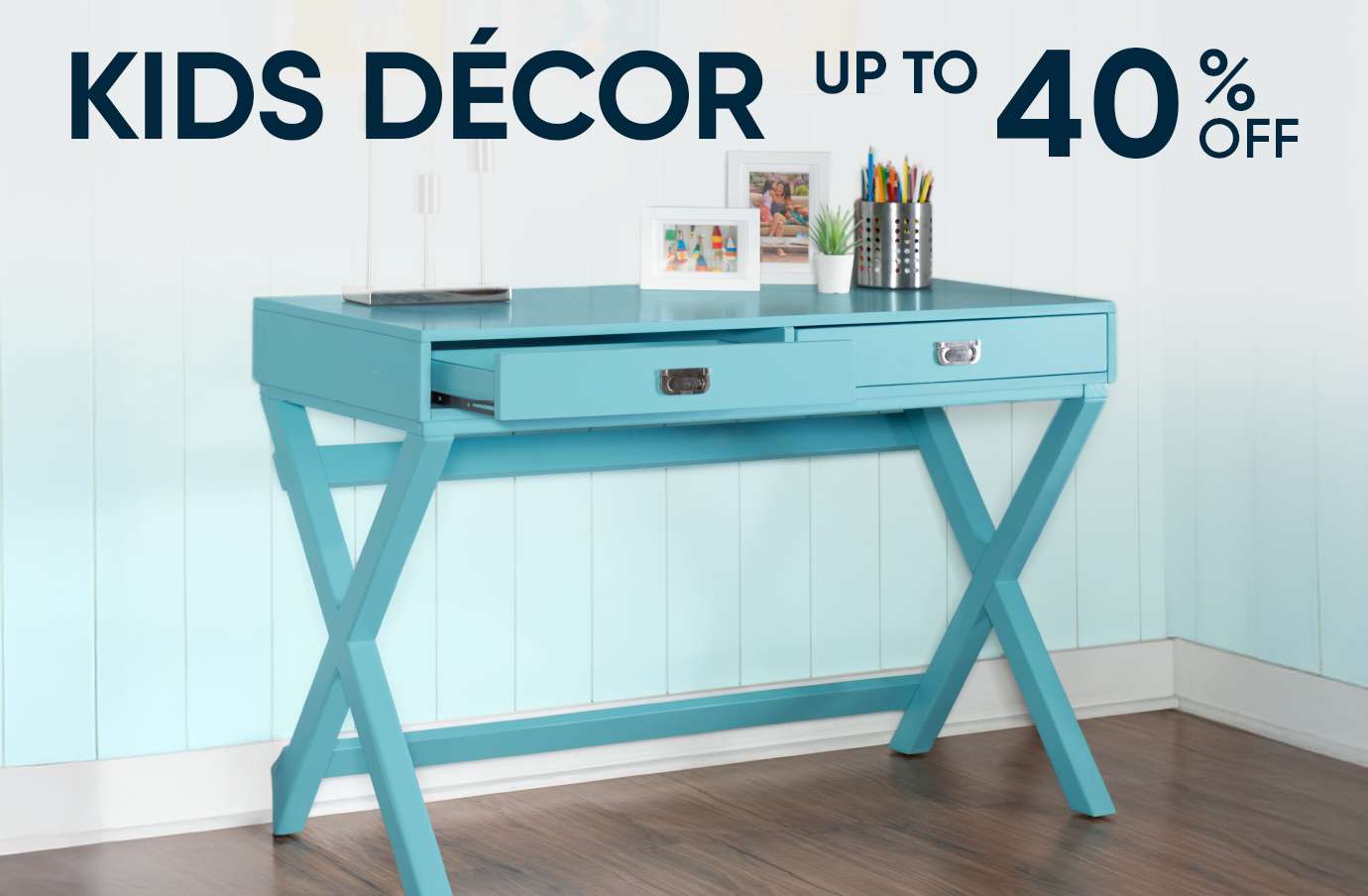 KIDS DÉCOR UP TO 40% OFF. A blue desk with an open drawer.

