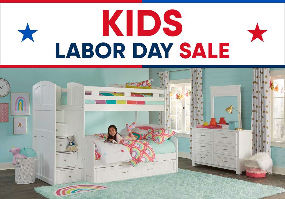 KIDS LABOR DAY SALE. A white bunk bed with a girl reading in the bottom bunk.
