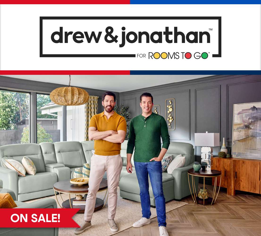 drew & jonathan for Rooms To Go. Two men standing in a living room with furniture. "ON SALE!"

