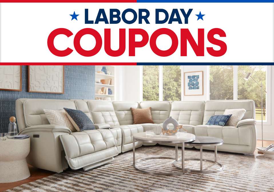 Labor Day Coupons. A large, white sectional sofa in a living room.
