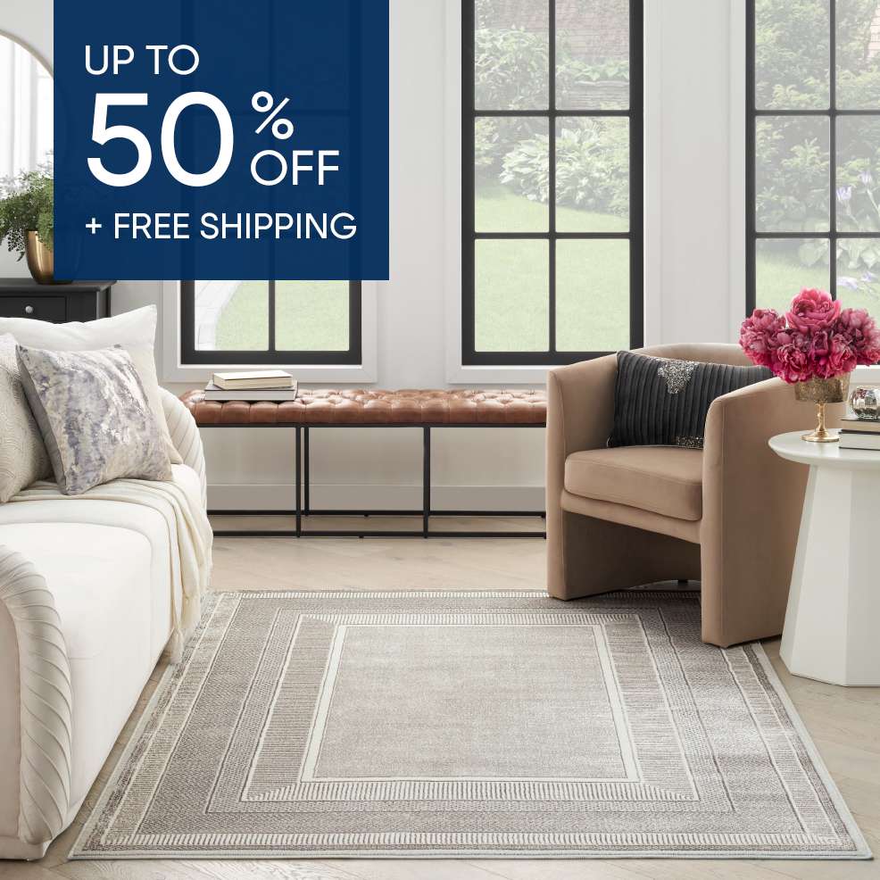 UP TO 50% OFF + FREE SHIPPING. A rug in a living room.
