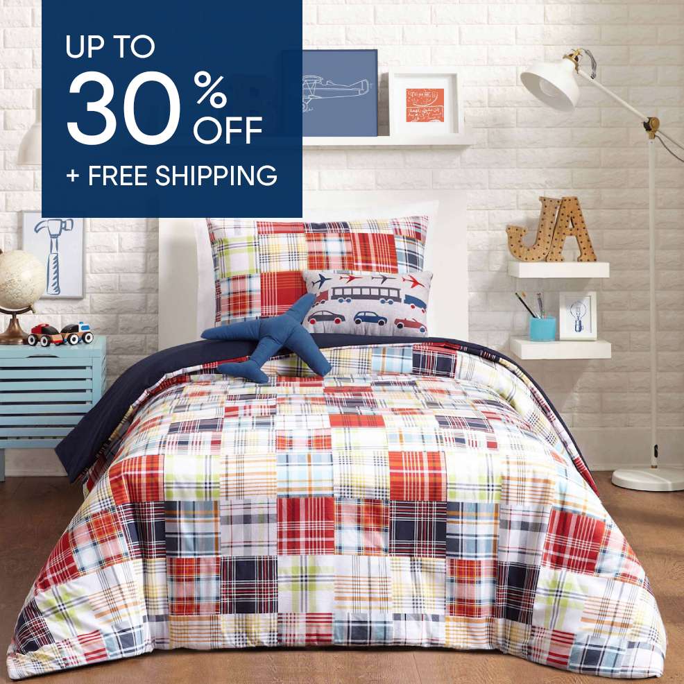 Up to 30% off + free shipping. A bed with a patchwork quilt and airplane-themed pillows.
